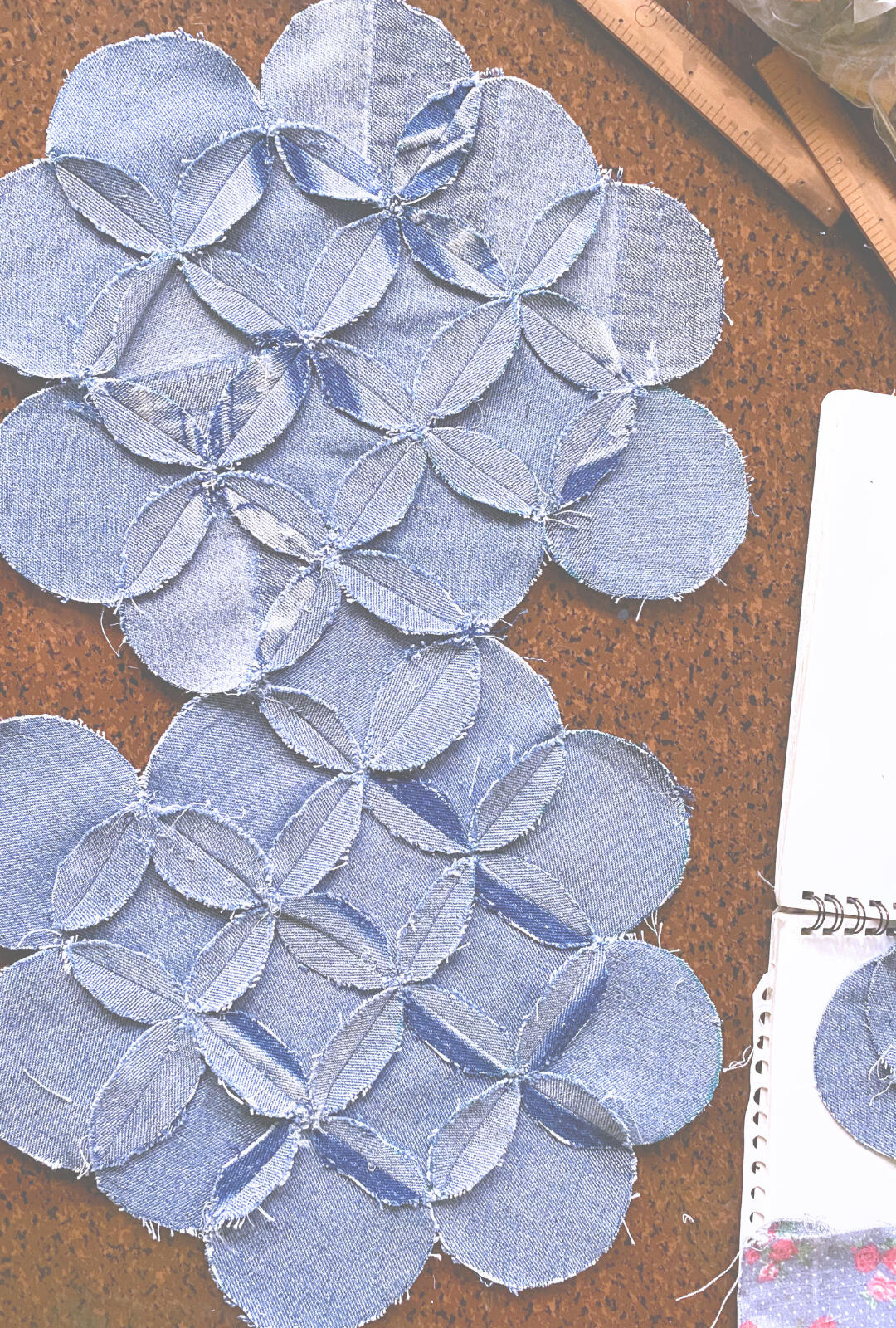 Reversible garments and bags constructed from denim and floral textiles through geometric patchwork and repairable design.