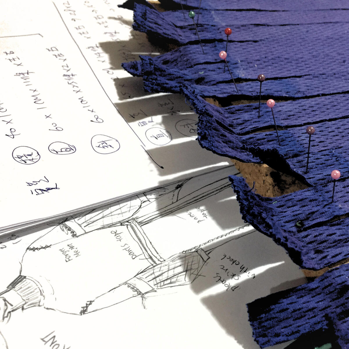 Close view of woven textile composed from reclaimed school uniform materials.