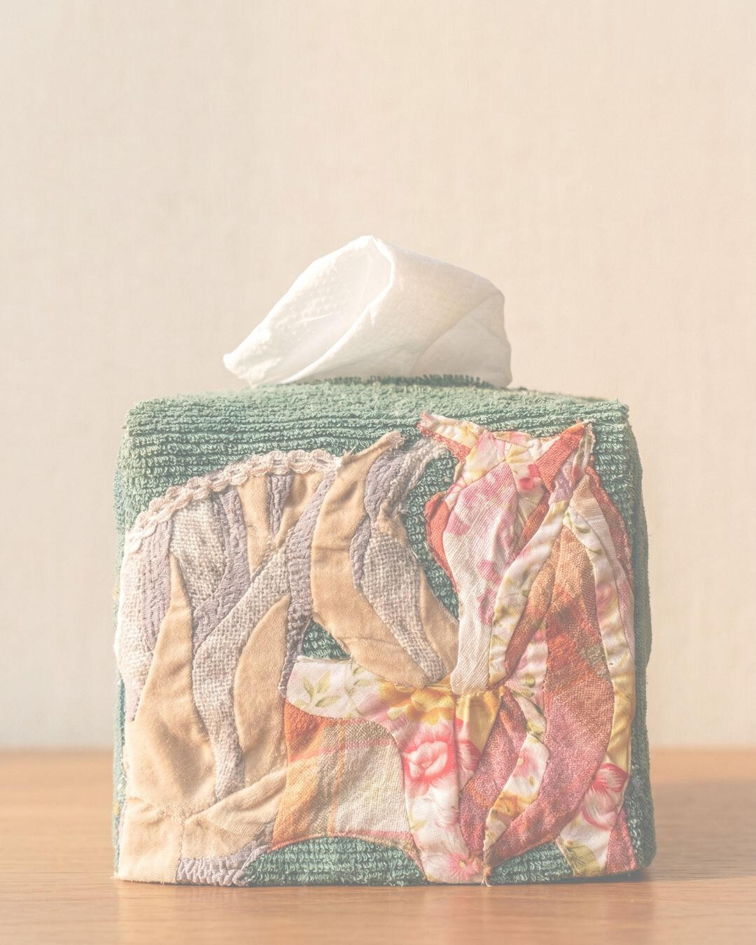 Handcrafted textile tissue case displayed on a wooden table in Đà Nẵng.