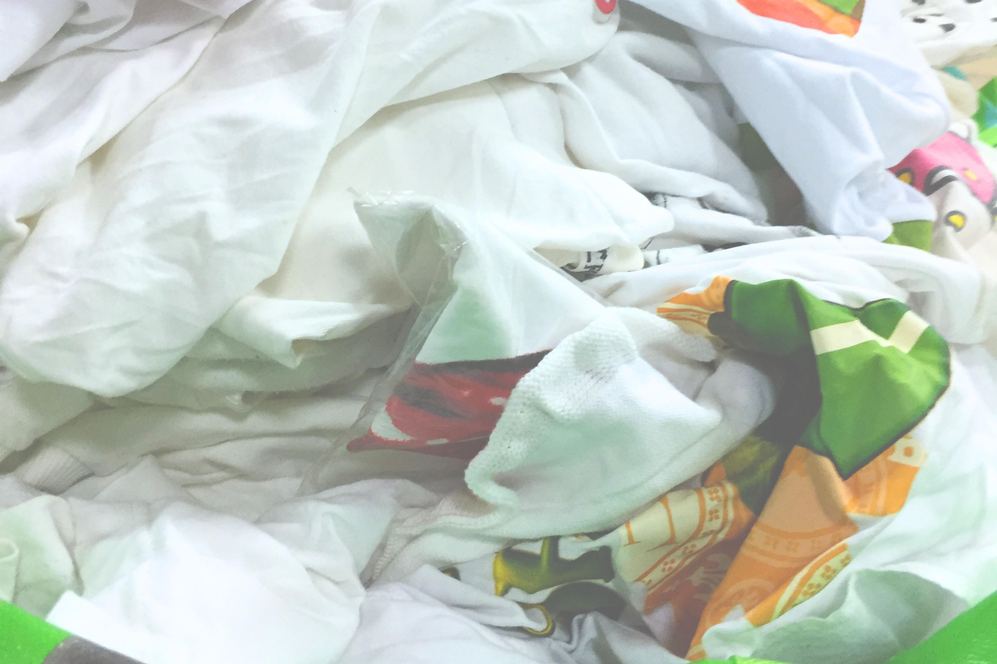 collected white T-shirts sorted in studio for textile recycling research