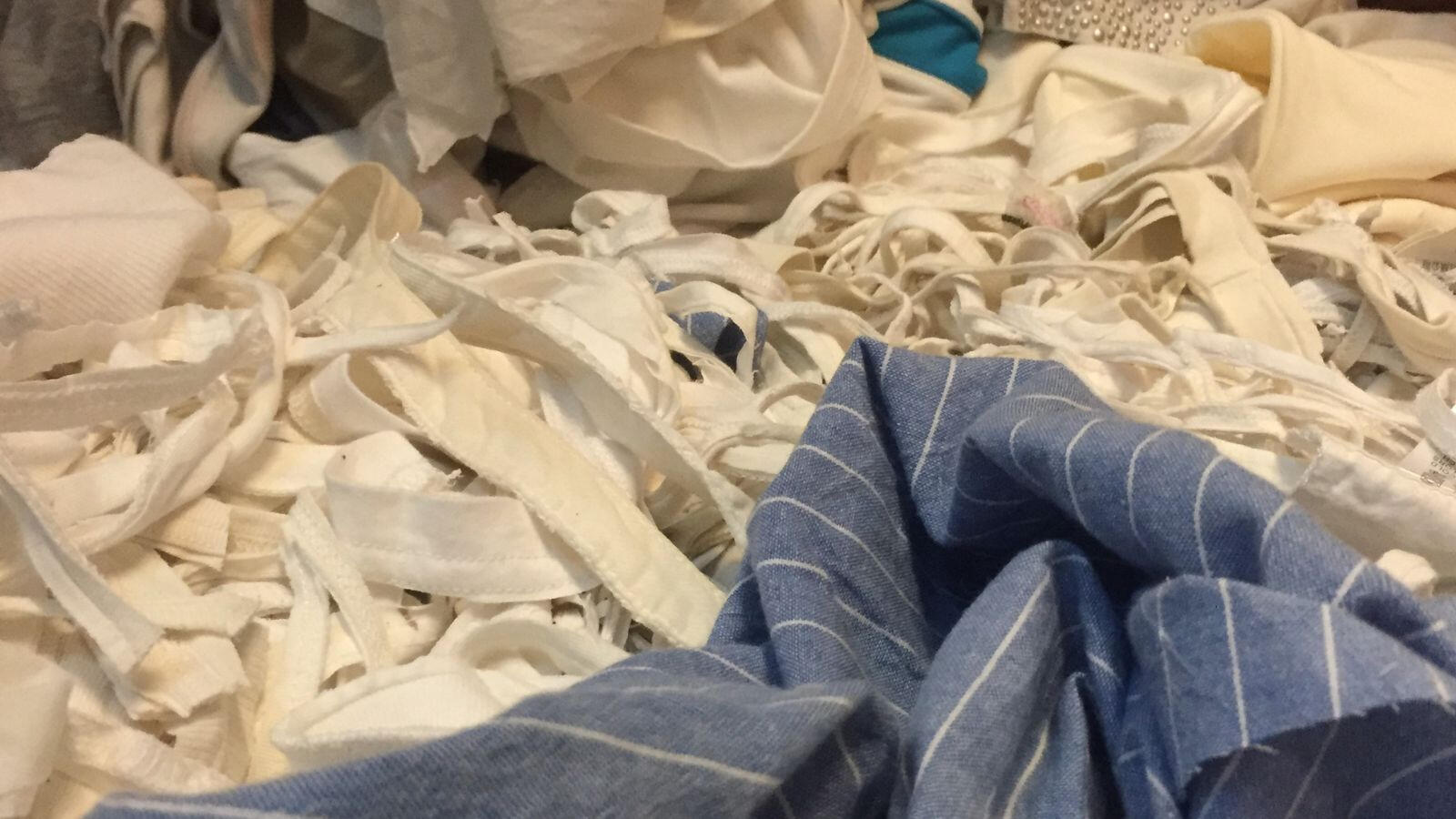Textile fibre recycling process showing breakdown of cotton materials